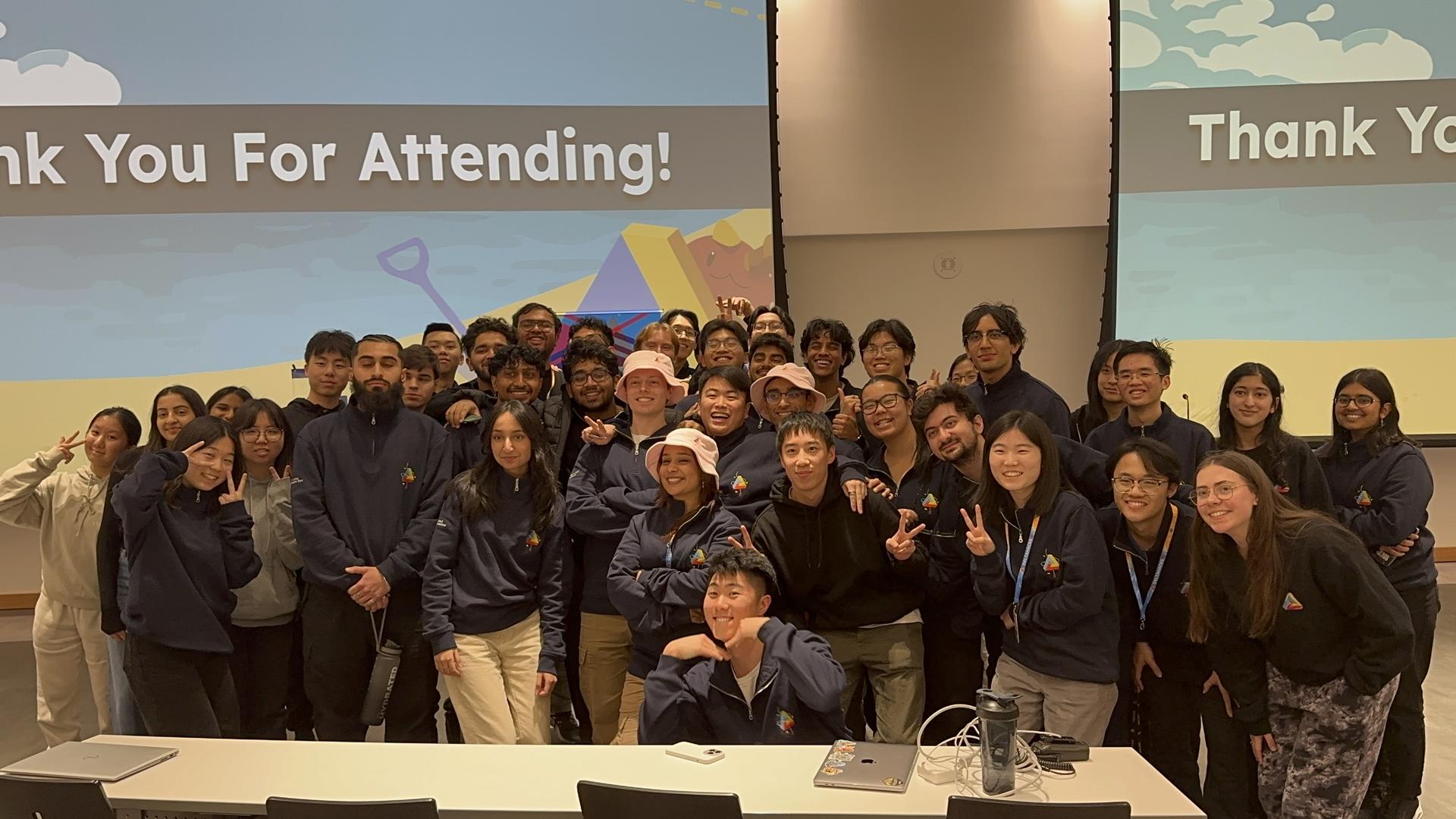 The entire DeltaHacks team smiling in a team photo, commending the end of DeltaHacks.